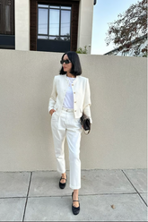 a lady in a white jacket and a pair of white pants